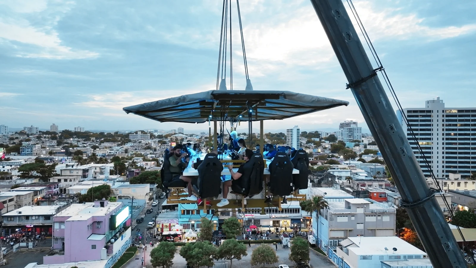 FlyDining platform suspended above the city at dusk