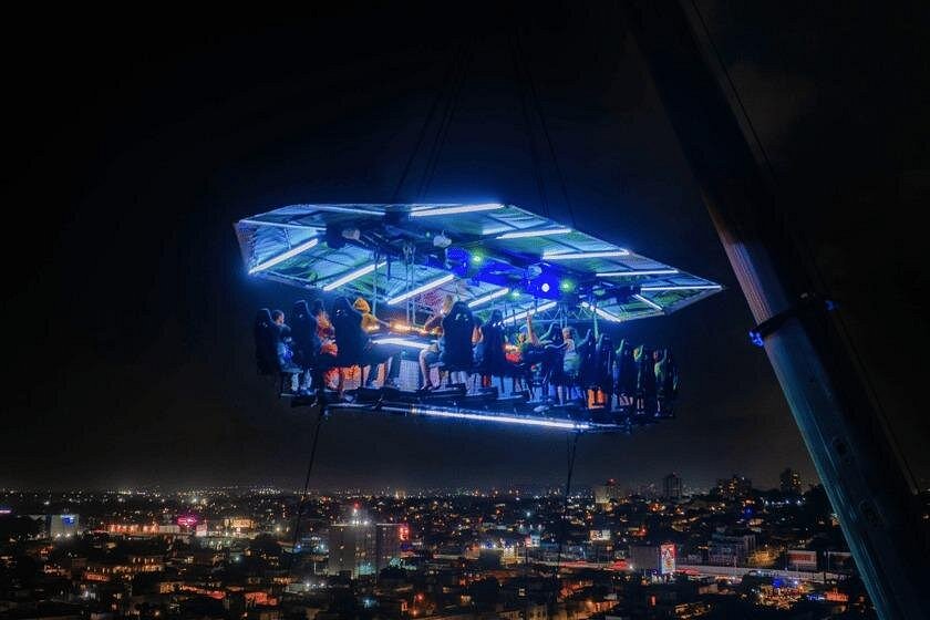 FlyDining platform illuminated above San Juan at night